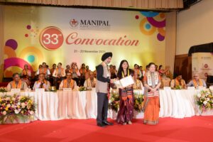 NEHA Sreekumar of MCON, Manipal receives gold medal from Chief Guest Bikram Singh Bedi and MAHE's First Lady Mrs. Vasanti R. Pai